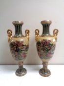 A pair of Japanese twin handled vases depicting geishas, height 43 cm.