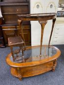 An oval glass topped coffee table together with a walnut pie crust edge D-shaped table and one