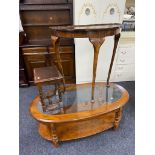 An oval glass topped coffee table together with a walnut pie crust edge D-shaped table and one