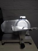 A stainless steel commercial meat slicer.