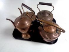 Three antique copper kettles together with a copper teapot.