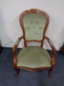 A beech framed Victorian style armchair upholstered in a green buttoned dralon