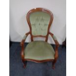 A beech framed Victorian style armchair upholstered in a green buttoned dralon