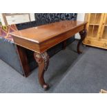 A mahogany console table on carved cabriole legs