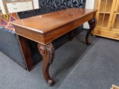 A mahogany console table on carved cabriole legs