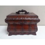A carved Eastern table box with lift out tray in a mahogany finish.