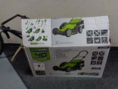 A boxed Green Works 40 volt electric lawn mower with grass box together with a Green Works 40 volt