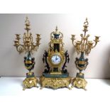An ornate highly decorative brass and marble three piece Imperial clock garniture.