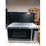 A Kenwood microwave together with a Hitachi 26'' LCD TV.