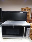 A Kenwood microwave together with a Hitachi 26'' LCD TV.