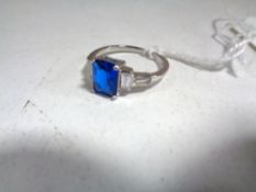 A sterling silver Art Deco style ring set with a blue stone, size N.