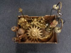 A box containing brass two way light fitting, chalk sun and moon ornaments, cherub table lamp etc.