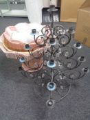 A wrought iron table standing candelabra with glass drops,