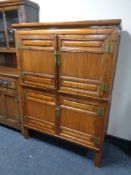 A Chinese style elm cabinet with bamboo panel doors.