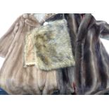 A mink three quarter length coat together with a further simulated fur coat and a fur wrap.