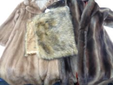 A mink three quarter length coat together with a further simulated fur coat and a fur wrap.