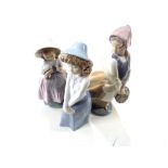 Three Nao figures, girl with flowers and girl with basket, together with one other.