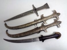 Four Persian knives, three in scabbards.