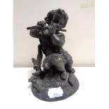 An antique Spelter figure, seated cherub with flute.