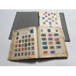 A Strand stamp album and on other containing a quantity of 20th century stamps of the world