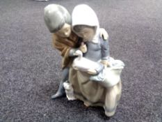 A Nao figure group, couple with duck.