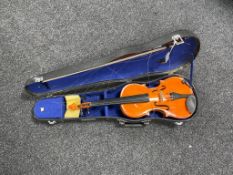 A Chinese violin and bow in case.