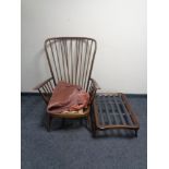 An Ercol elm and beech wingback armchair with stool (no cushions,