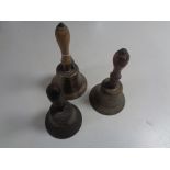 Three antique wooden handled hand bells