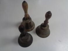 Three antique wooden handled hand bells