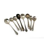Eight silver mustard spoons.