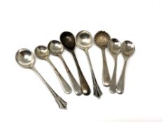Eight silver mustard spoons.