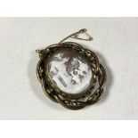 A Victorian mourning cameo brooch.