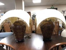 A pair of bulbous pottery table lamps on wooden bases with tasselled shades (a/f)