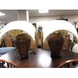 A pair of bulbous pottery table lamps on wooden bases with tasselled shades (a/f)