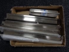 A box containing 13 stainless steel kitchen cabinet door handles (new).