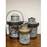 A set of three graduated aluminium churns with handles