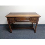 A good quality carved oak refectory hall table, fitted three drawers.