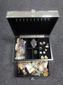 A contemporary mirrored jewellery box containing a large quantity of costume jewellery to include