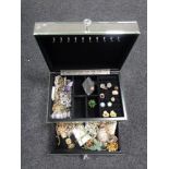 A contemporary mirrored jewellery box containing a large quantity of costume jewellery to include