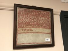 A Late 19'th Century sampler, 26 cm x 26 cm, with interesting hand-written note taped verso, framed.