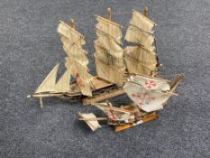 Two wooden models of three masted ships.