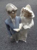 A Nao figure group, bride and groom.