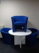 A circular white office pedestal table and three tub chairs upholstered in a blue fabric