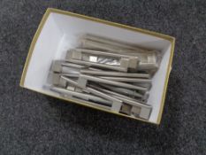 A box containing 17 stainless steel kitchen cabinet door handles (new).