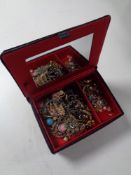 A contemporary velvet jewellery box containing costume jewellery to include beaded necklaces,