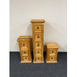 A narrow Mexican pine five drawer chest together with matching three drawer and two drawer chests.