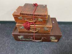 Three 20th century leather cases together with a leather bound photograph album