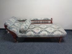 An antique mahogany framed chaise longue upholstered in brocade fabric
