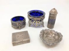 A group of silver and white metal items comprising salts with blue glass liners, sifter,
