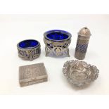 A group of silver and white metal items comprising salts with blue glass liners, sifter,